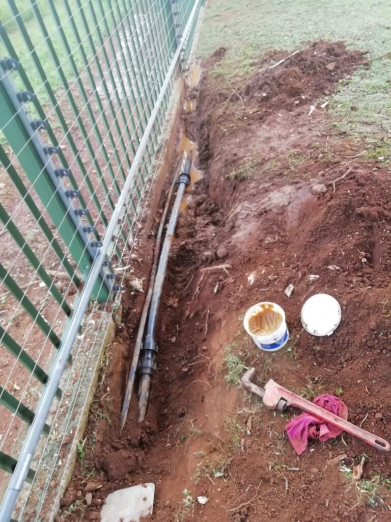 Water pipe investigation beside a boundary fence