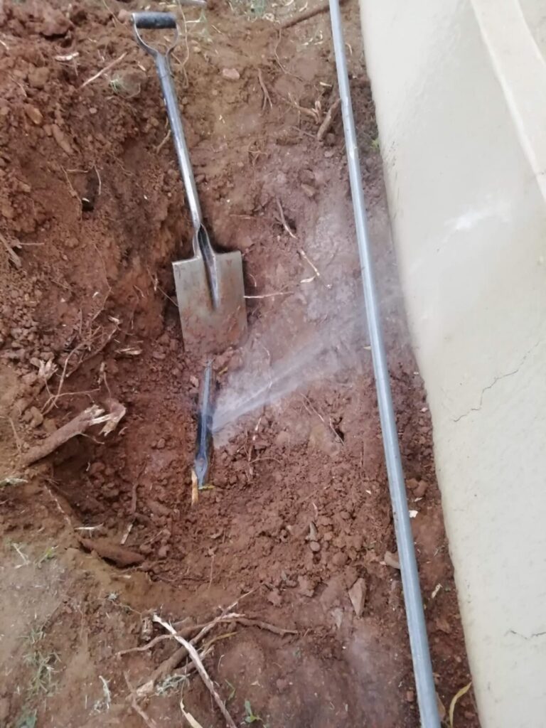 Exposed pipework in an excavated trench